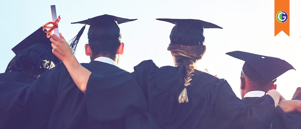 Current image: In this image, a group of graduates wearing black caps and gowns stand arm-in-arm, facing away from the camera toward a bright sky. In the top right corner, an orange bookmark shape contains the circular green and purple GEAR UP logo. One graduate in the image holds up a diploma with an orange ribbon as they celebrate their graduation together.